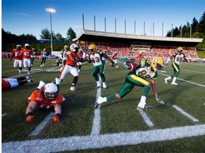 Edmonton Eskimos’ Skye Dawson (88) returns a kick as B.C. Lions’ Alex Hoffman-Ellis, bottom left, dives to make the tackle but misses during the first half of a pre-season CFL football game in Vancouver, B.C., on Friday June 19, 2015.