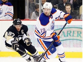 Edmonton Oilers defenceman Justin Schultz handles the puck in front of Sidney Crosby of the Pittsburgh Penguins during an NHL game at Consol Energy Center in Pittsburgh on March 12, 2015.