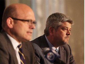 Edmonton Oilers president and general manager Peter Chiarelli, left, announces Todd McLellan as the NHL team’s new head coach on Tuesday.