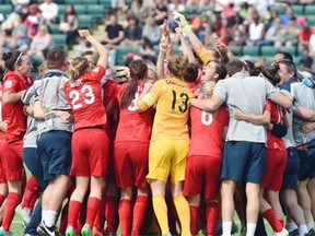 England celebrates after they beat Germany 1-0 for the bronze in extra time at Commonwealth Stadium in Edmonton. July 4, 2015.