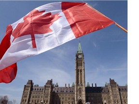 A Canadian flag waves on Parliament Hill in Ottawa on April 15, 2013.