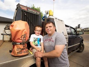 Fort McMurray resident Rene Dempsey, shown with son Garrett, 5, says the temptation of a shipbuilding job isn’t likely to lure him back to Atlantic Canada.