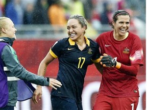 Forward Kyah Simon, centre, and goalkeeper Lydia Williams celebrate Australia’s victory against Brazil in a Women’s World Cup Round of 16 soccer match at Moncton Stadium in Moncton, N.B., on June 21, 2015.