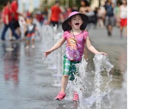 Four-year-old Olivia Giambattista had fun running through the new fountains as thousands of people turned up for Canada Day celebrations at the legislature on July 1, 2015.