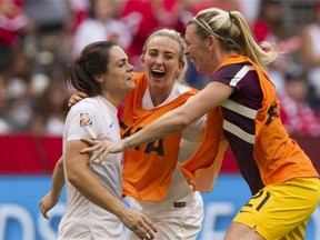 From left, Carly Telford, Siobhan Chamberlain and Toni Duggan celebrate England’s 2-1 victory over Canada in a Women’s World Cup quarter-final Saturday at BC Place Stadium in Vancouver.