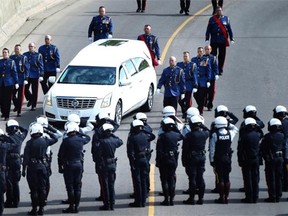 The funeral procession for Edmonton police Const. Daniel Woodall comes down Grierson Hill to the Shaw Conference Centre in Edmonton on June 17, 2015.