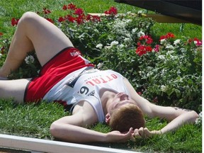 Geoff Lawson falls into a flower bed at the end of the 4x400-metre junior men’s relay at the Canadian track and field championships at Foote Field on Sunday.