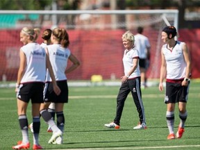 German head coach Silvia Neid (C) looks on as her players warm up during a training session at the FIFA Women’s World Cup in Edmonton, Canada on July 2, 2015. Germany meets England on Saturday in the bronze medal match.