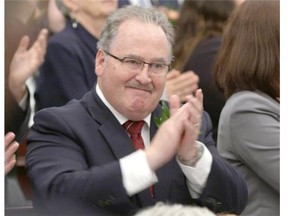 NDP government house leader Brian Mason applauds after Alberta Lt.-Gov. Lois Mitchell delivered the speech from the throne at the Alberta legislature on June 15, 2015.