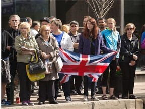 People line Jasper Avenue during the funeral procession for Const. Dan Woodall on June 17, 2015. Woodall emigrated from England to join the Edmonton Police Service in January 2007. He was with the hate crimes unit at the time of his slaying.