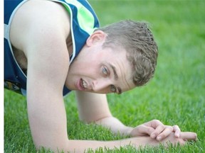 Holden Gill collapses in the grass after winning the 400 metre dash Ambulatory Para Ambulatory at the 2015 Canadian Track and Field Championships at Foote Field in Edmonton.