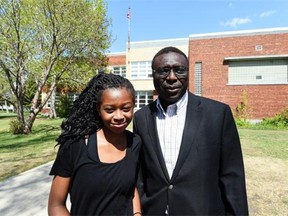 Ibrahim Karidio with his daughter Fatima, 14, in front of Ecole Gabrielle-Roy in Edmonton on Wednesday, May 13, 2015.