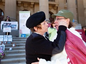 Jamie Sullivan is comforted by her mother Marilyn Koren, left, in front of the legislature in April 11, 2012, during a demonstration recognizing the one year anniversary of Jamie’s daughter Delonna Sulivan, who died within six days of being taken into child protective custody