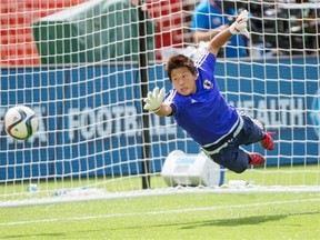 Japan goalkeeper Ayumi Kaihori dives for the ball  during the a training session on Friday in Edmonton.