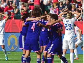 Japan’s players celebrate their 2-1 win over England in a Women’s World Cup semifinal at Commonwealth Stadium on Wednesday.