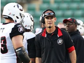 Jason Maas, offensive coordinator for the Ottawa RedBlacks, watches from the sideline during July CFL game action against the the Edmonton Eskimos.