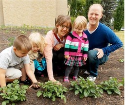 Jennifer and Mark Postma with their daughters Celina, 6, and Maggie, 2, along with friend Cashtion, 6, tend a row of potatoes they helped to plant at St. Andrews United Church. The couple is among the millennial generation that Brian Minter says has different gardening priorities from their parents. Having less interest in flowers, they focus more on growing food and maintaining a healthy environment.
