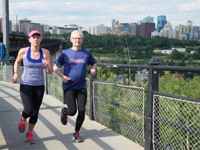 Julia LeConte and Ed Wagner from the Running Room jogging on the High Level Bridge.
