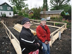 Karly Coleman, left, and Andy Hegst on the site of the future net zero garage suite in their west side home’s backyard.