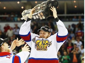 Oil Kings captain Griffin Reinhart lifts the Memorial Cup after Edmonton beat the Guelph Storm 6-3 in the championship game of the Memorial Cup CHL hockey tournament in London, Ont., on Sunday, May 25, 2014.