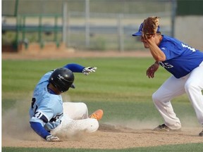 Leduc Milliteers Mykel Ruptash (left) slides safely into second base as the ball flies past Blue Willow Angels second baseman (right/#18) during the Blue Willow Invitational, a North Central Alberta Baseball League tournament held at Telus Field in Edmonton on July 10, 2015.