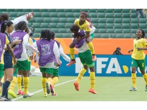 Madeleine Ngono Mani (9) celebrates her winning goal, jumping into a teammate’s arms as Cameroon defeats Switzerland 2-1 in a Group C Women’s World Cup match at Commonwealth stadium.