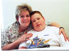 Maureen Harland and her son Trevor Proudman when he was 15. He was found unresponsive and face down in a police van last year. A fatality inquiry began Monday into the circumstance of his death.