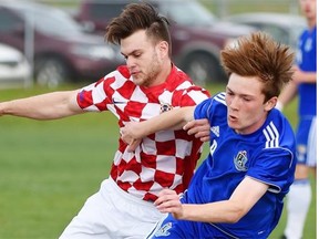 Morgan Graham, right, of St. Albert Impact 1 (FC Edmonton academy team) gets knocked off the ball by Croatia United’s Scott Dickson during an Edmonton District Soccer Association’s Premier Division match at Riel Park in St. Albert on June 4, 2015.