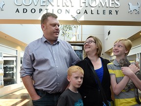 Clint Rempel, his wife Tamara and children Erin, 12, and Samuel, 6, adopt Henry the warrior kitten at the Edmonton Humane Society on Monday July 6, 2015.
