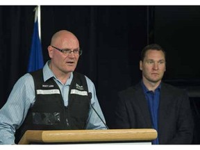 Scott Long, executive director of provincial operations, Alberta Emergency Management Agency, left, and Deron Bilous, Minister of Municipal Affairs provide a wildfire update on July 3, 2015.