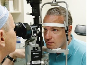 Ken Ross (right) gets his eyes examined by ophthalmologist Dr. Ian MacDonald at the Royal Alexandra Hospital following gene therapy to preserve and potentially restore vision for people with a genetic disorder that leaves people blind by middle age.