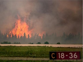 Flames leap from a wildfire at the airport near La Ronge, Saskatchewan.