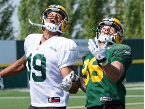 Paris Jackson, left, and Aaron Grymes go for the ball at the Edmonton Eskimos training camp at the Fuhr Sports Park in Spruce Grove on June 3, 2015.