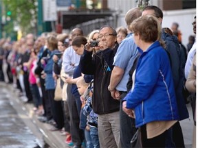 People lined up along Jasper Avenue the morning of Wednesday, June 17, 2015 to watch the funeral procession for slain Const. Daniel Woodall.