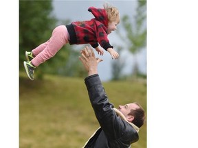 Piper Gravel, 2, had fun flying high with her dad Albert during the annual Root For Trees Fest in Beaumaris Park in Edmonton on Saturday, June 12, 2015.