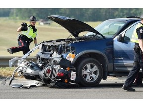 Police investigate the scene after a motorcyclist as killed in a collision with a Ford Explorer at the intersection of Callingwood Road and Anthony Henday Drive on July 10, 2015.