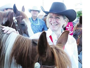 Premier Rachel Notley gets ready to ride in the Calgary Stampede parade on Friday.
