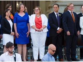 Premier Rachel Notley (far right) and her 11 cabinet ministers are sworn in on the legislature steps in Edmonton on May 24, 2015. Shannon Phillips (far left) is the first Alberta minister responsible for the status of women since 1997.