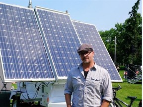 Randall Benson stands by the portable solar panels he brought to power the rally for green jobs at the legislature Saturday.  Benson, a former oilsands worker, says there’s a big demand for solar energy in Alberta.