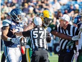 CFL referees, like the players, are adjusting to new rules this season. Here referees and Edmonton Eskimos Odell Willis (41) try to break upToronto Argonauts Brandon Whitaker (3) and JC Sherritt (47) during the June 27 game in Fort McMurray that the Argos won 26-11.