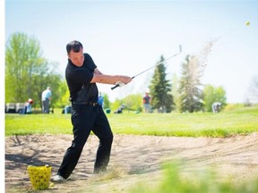 Robb James of the Victoria Driving Range teaches golfers how to get out of the sand trap in one swing while at the Cardiff Golf & Country Club on May 22, 2015.