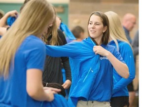 Ryan Jackson / Edmonton Journal Volleyball athlete Skye Thomeson, 17, from Calgary, tries on her new Team Alberta uniform Saturday at Strathcona Christian Academy in Sherwood Park. Hundreds of young Alberta athletes gathered in advance of the upcoming 2015 Western Canada Summer Games being held in Fort McMurray.