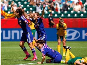 Saki Kumagai, Rumi Utsugi and Azusa Iwashimizu celebrate a Japanese goal scored by Mana Iwabuchi against Australia during a Women’s World Cup quarter-final at Commonwealth Stadium on Saturday.