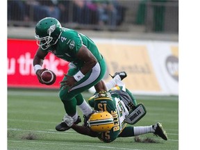 Saskatchewan Roughriders quarterback Darian Durant (4) is sacked by Edmonton’s Deion Belue (15) during pre-season CFL action in Fort McMurray on June 13, 2015. The Eskimos won the Northern Kickoff 31-24.