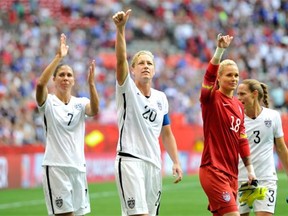 Shannon Boxx (7), Abby Wambach (20), Ashlyn Harris (18), and Christie Rampone (3) of the United States celebrate with teammates after the 1-0 victory against Nigeria in the Group D match of the FIFA Women’s World Cup Canada 2015 at BC Place Stadium on June 16, 2015 in Vancouver, Canada.