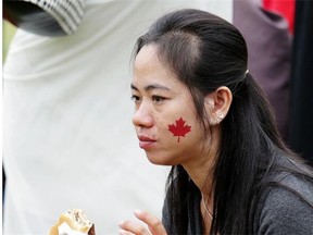 Sivchheng Tang eats a hamburger at Norquest College’s Westmount Campus on June 30, 2015, where approximately 450 English as a Second Language students from Norquest College celebrated Canada’s 148th birthday.