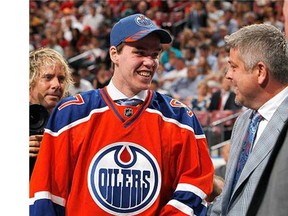 Connor McDavid talks to head coach Todd McClellan (R) after being selected first overall by the Edmonton Oilers during Round One of the 2015 NHL Draft at BB&T Center on June 26, 2015 in Sunrise, Florida.