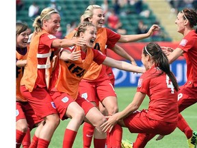 England players celebrate after scoring against Germany in FIFA Women’s World Cup soccer action in Edmonton.