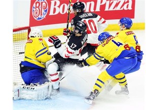 Team Canada’s Connor McDavid (17) is checked by Team Sweden’s Oliver Kylington (4) and Gustav Forsling (8) in a December 2014 exhibition game in advance of the IIHF World Junior Championships. Kylington is one player the Oilers might consider drafting if they are looking for a defenceman.