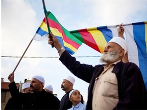 In this photo taken June 14, 2015, members of Israel’s Druze minority wave flags during a march in the Druze village of Yarka, Israel. They’re concerned about their brethren in Syria.